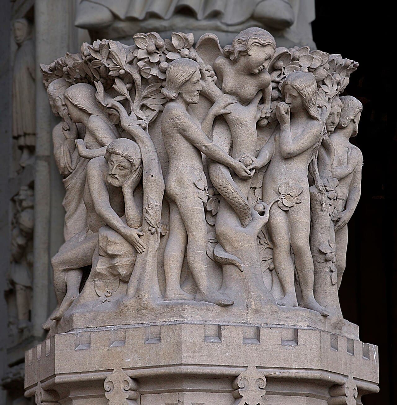 The story of the Eden Garden. The temptation of Adam & Eve by the devil. Pedestal of the statue of Madonna with Child, western portal (of the Virgin), of Notre-Dame de Paris, France